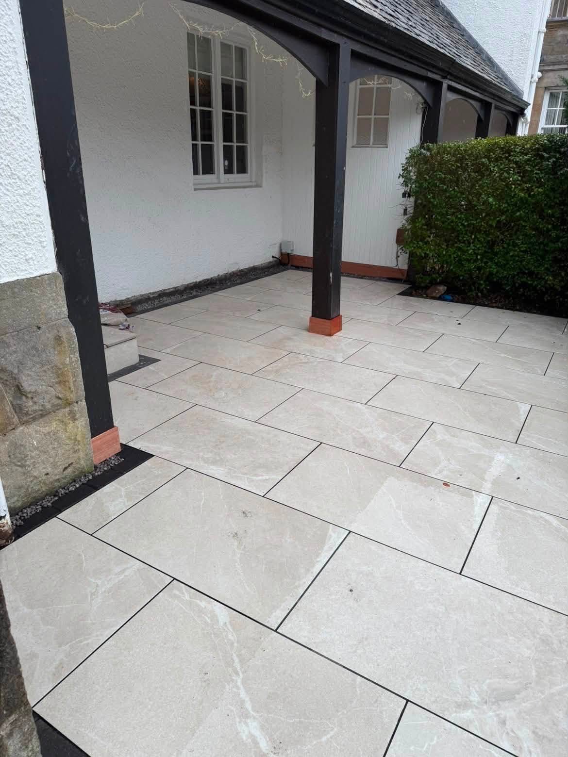 Beige porcelain patio under a covered porch in Glasgow